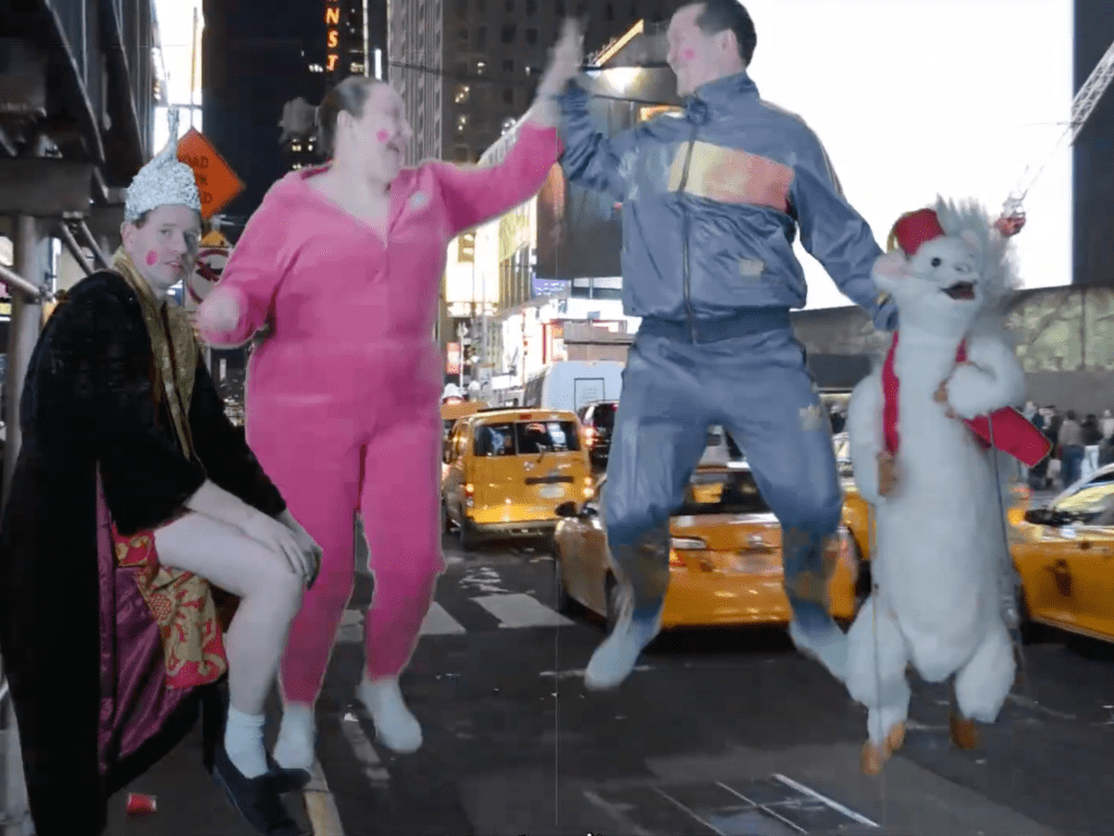 Two aliens dressed in track suits high-five in Times Square traffic, with a man in a tinfoil hat casually sitting on their left, and a human-sized weasel puppet standing on their right.